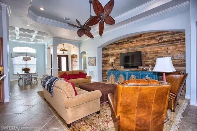 9633 Firenze Circle Naples, FL 34113 - Photo 6 of 25 a living room with furniture and a flat screen tv