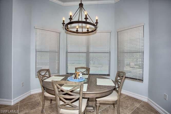 9633 Firenze Circle Naples, FL 34113 - Photo 9 of 25 a view of a dining room with furniture window and wooden floor