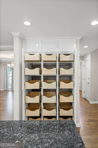 a view of kitchen with granite countertop cabinets and refrigerator
