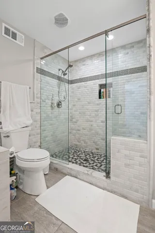 a view of a room with wooden floor and a ceiling fan