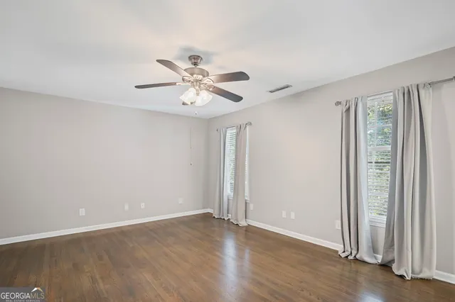 a bathroom with a tub a sink and a large mirror