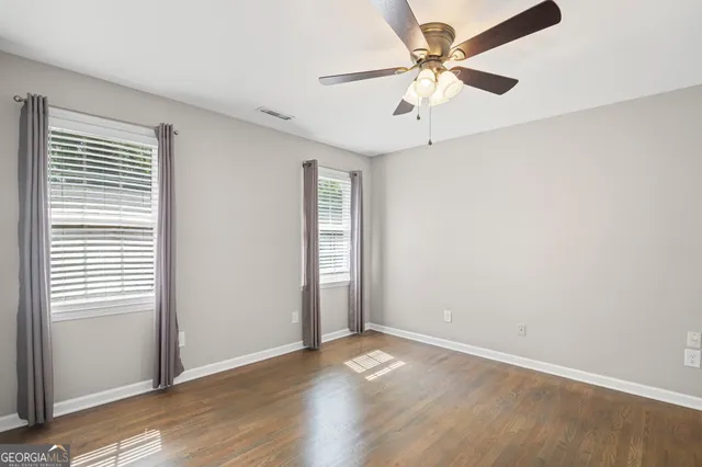 a bathroom with a granite countertop sink and a window