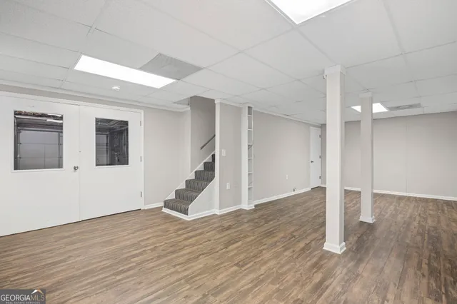 a view of an empty room with a window and a ceiling fan