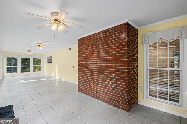 a view of an entryway with a floor to ceiling window and a ceiling fan