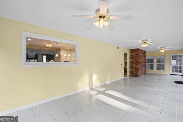 a view of a livingroom with a ceiling fan and window