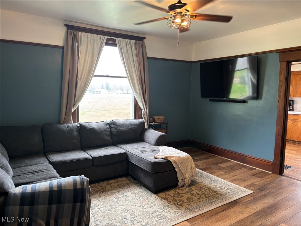 6380 Old River Road Philo, OH 43771 - Photo 9 of 26 Living room featuring hardwood / wood-style floors, baseboards, and a ceiling fan