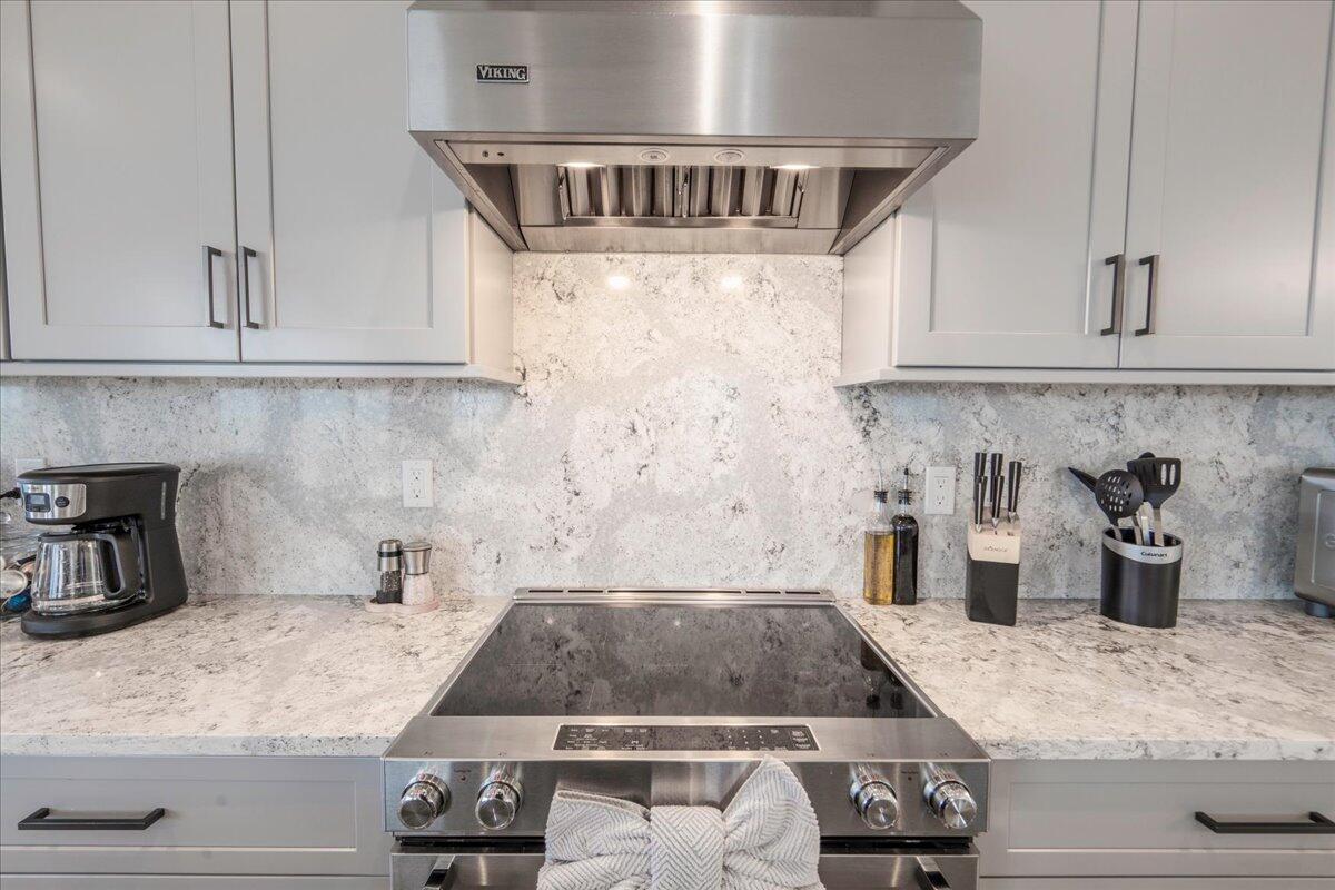 810 39th Street, Unit GULF Marathon, FL 33050 - Photo 15 of 113 a kitchen with kitchen island granite countertop a sink a stove and white cabinets