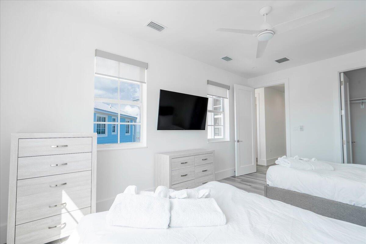 810 39th Street, Unit GULF Marathon, FL 33050 - Photo 25 of 113 a bedroom with a bed a flat screen tv and dresser