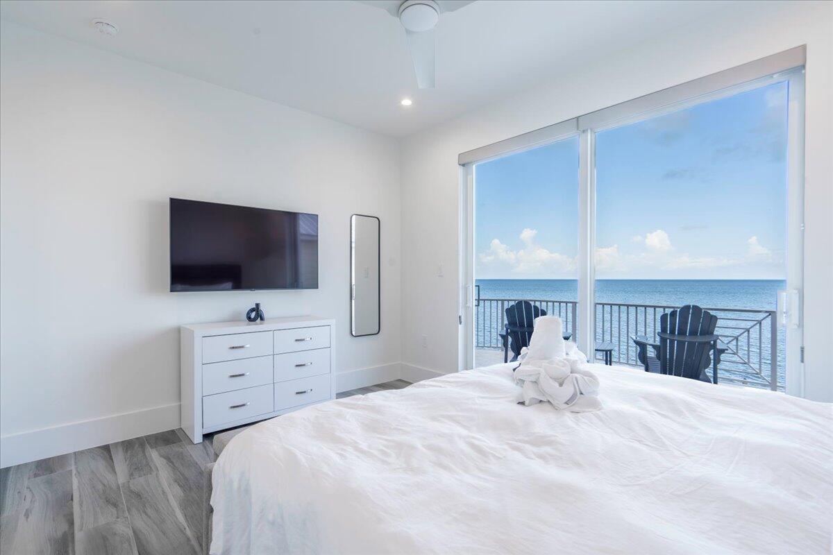 810 39th Street, Unit GULF Marathon, FL 33050 - Photo 43 of 113 a bedroom with a bed and a flat screen tv