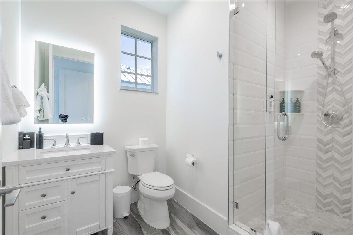 810 39th Street, Unit GULF Marathon, FL 33050 - Photo 44 of 113 a bathroom with a toilet a sink and a mirror