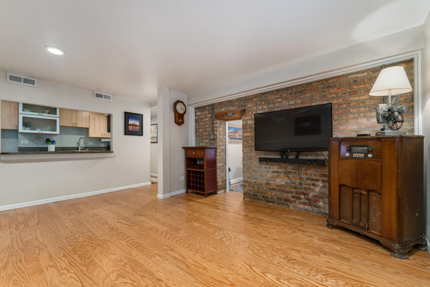 4633 North Racine Avenue, Unit GN Chicago, IL 60640 - Photo 4 of 25 a view of living room kitchen with stainless steel appliances cabinets and flat screen tv