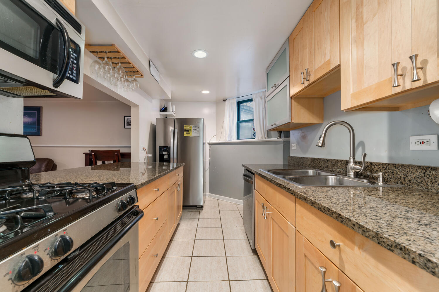 4633 North Racine Avenue, Unit GN Chicago, IL 60640 - Photo 7 of 25 a kitchen with stainless steel appliances granite countertop a sink stove and cabinets