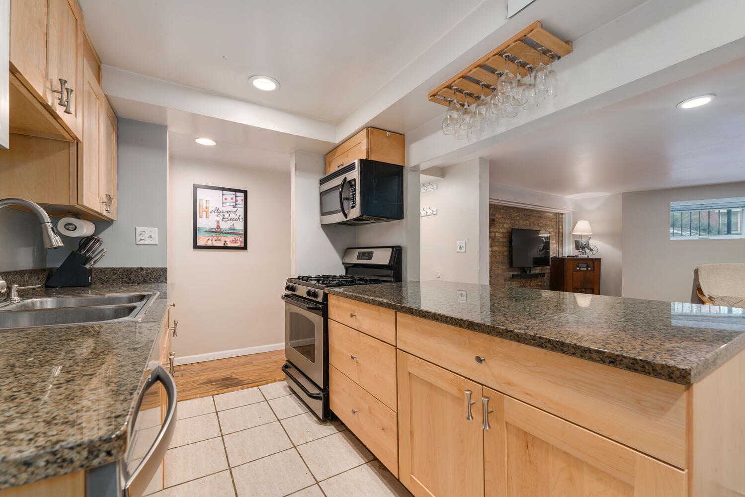 4633 North Racine Avenue, Unit GN Chicago, IL 60640 - Photo 8 of 25 a kitchen with stainless steel appliances granite countertop a sink stove and refrigerator