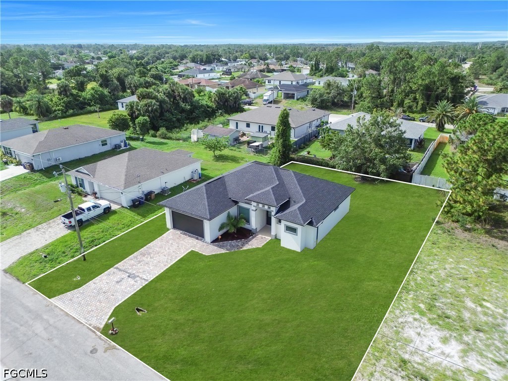 3509 38th Street Southwest Lehigh Acres, FL 33976 - Photo 38 of 47 an aerial view of a house with a garden