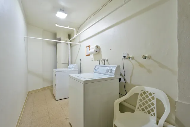 a room with a washing machine and a mirror