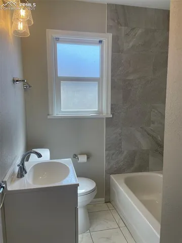 a bathroom with a sink a toilet and bathtub
