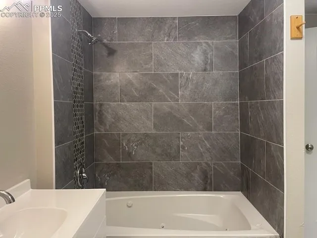 a bathroom with a bathtub and a shower