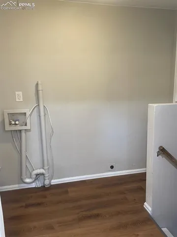 a view of a room with wooden floor