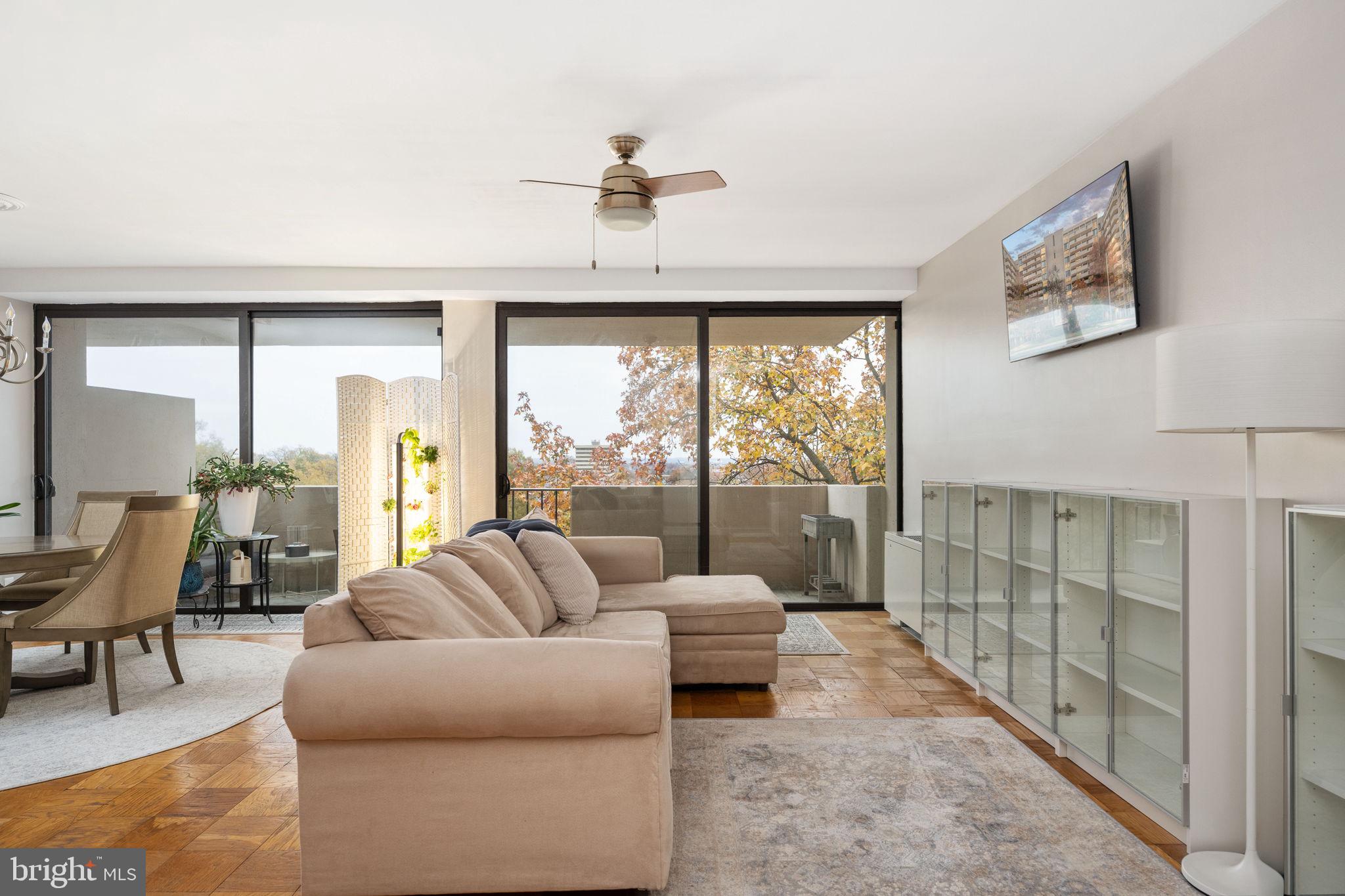 4141 North Henderson Road, Unit 702 Arlington, VA 22203 - Photo 13 of 69 a living room with furniture large windows and a chandelier