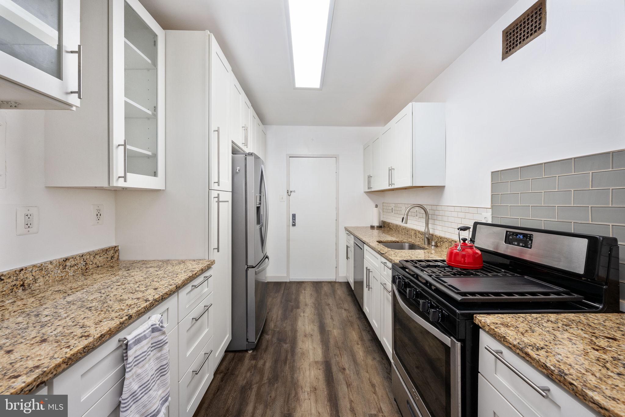 4141 North Henderson Road, Unit 702 Arlington, VA 22203 - Photo 16 of 69 a kitchen with stainless steel appliances granite countertop a stove and a sink