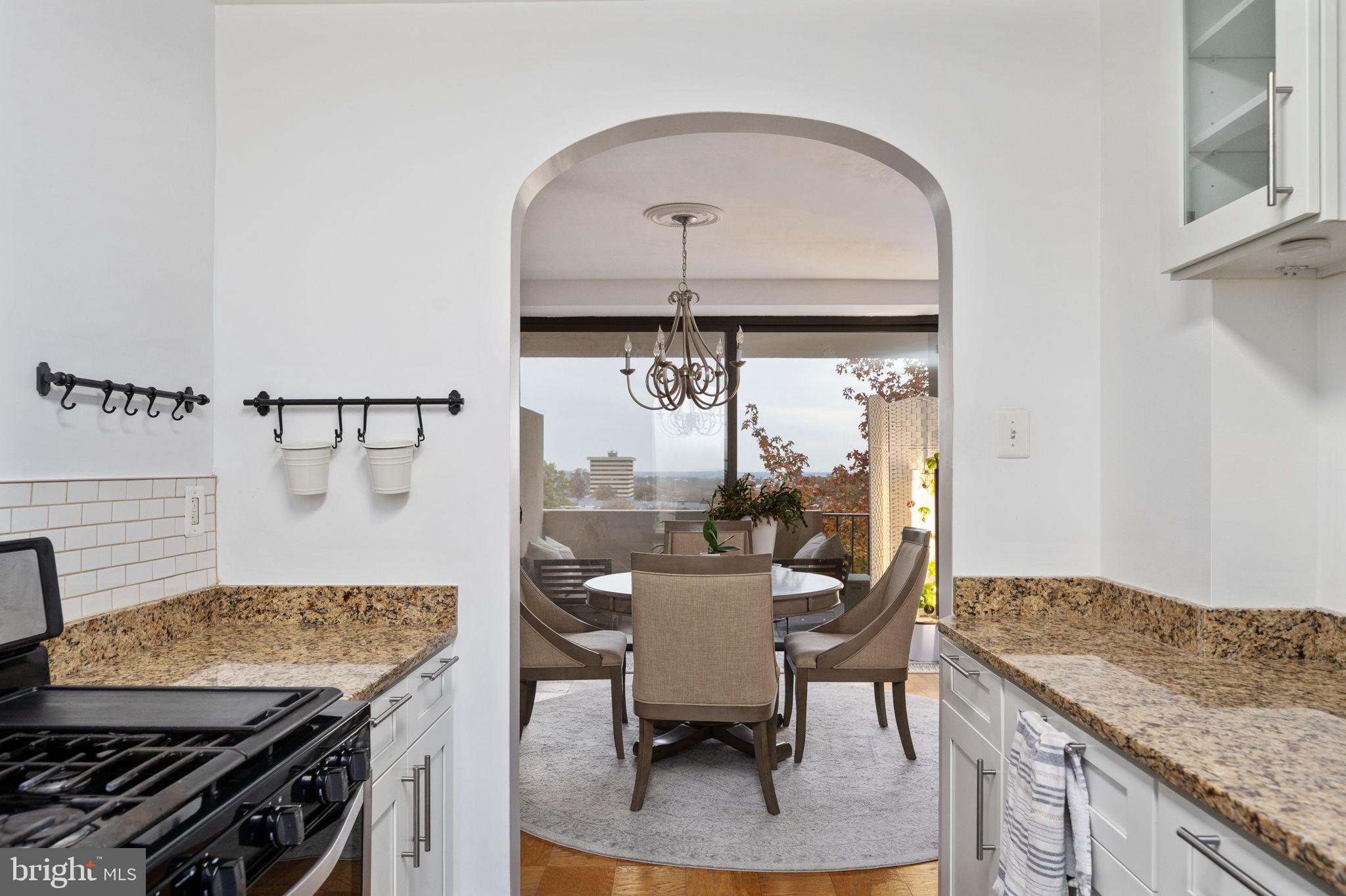 4141 North Henderson Road, Unit 702 Arlington, VA 22203 - Photo 20 of 69 a kitchen with a sink a stove and chairs