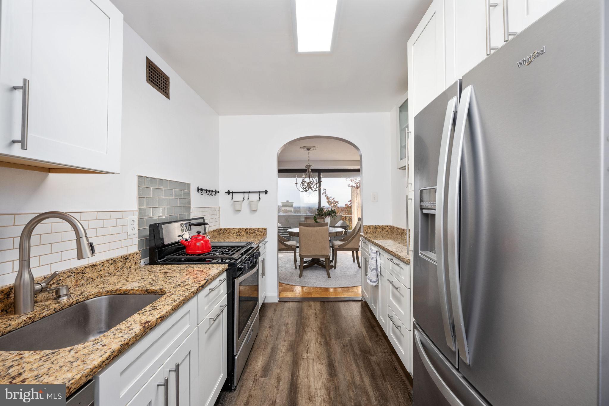 4141 North Henderson Road, Unit 702 Arlington, VA 22203 - Photo 3 of 69 a kitchen with stainless steel appliances granite countertop a sink stove and refrigerator