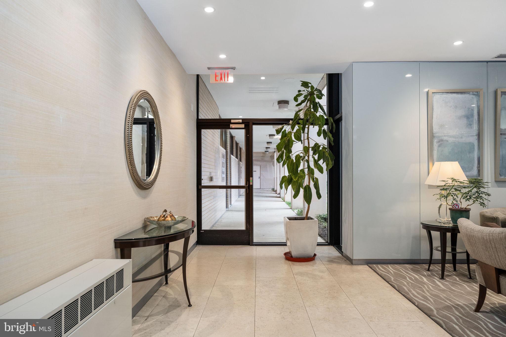4141 North Henderson Road, Unit 702 Arlington, VA 22203 - Photo 9 of 69 a living room with furniture and a potted plant