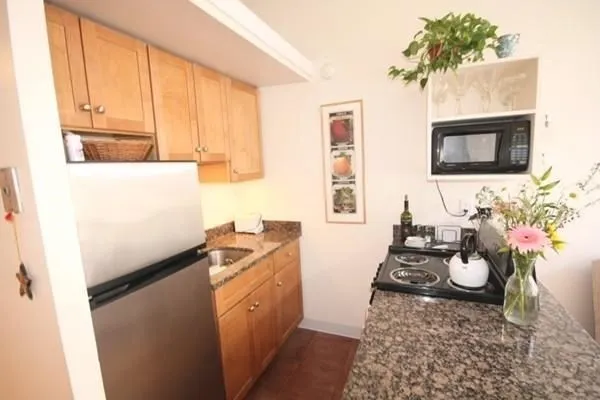 a kitchen with sink refrigerator and stove top oven