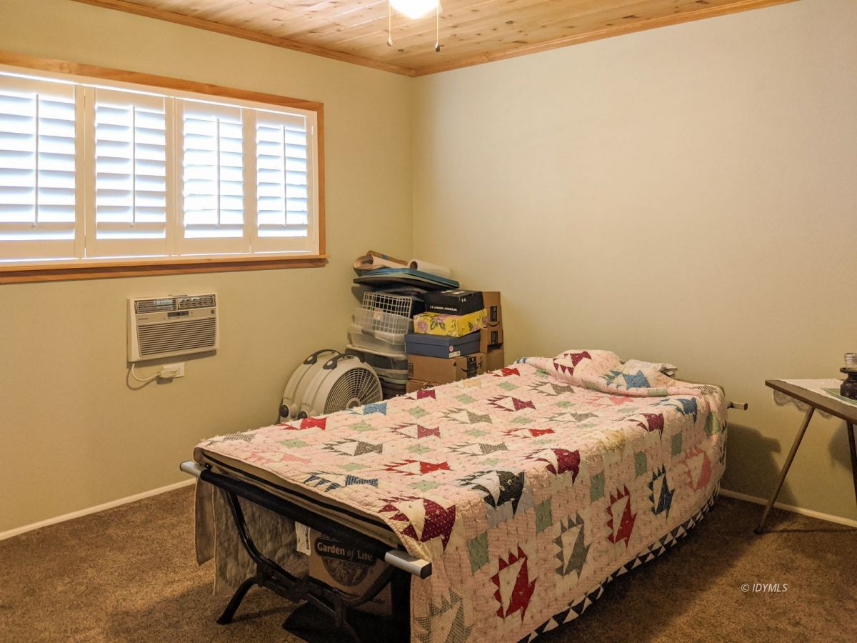 26523 Pine Avenue Idyllwild, CA 92549 - Photo 19 of 56 a bedroom with a bed a table and chair