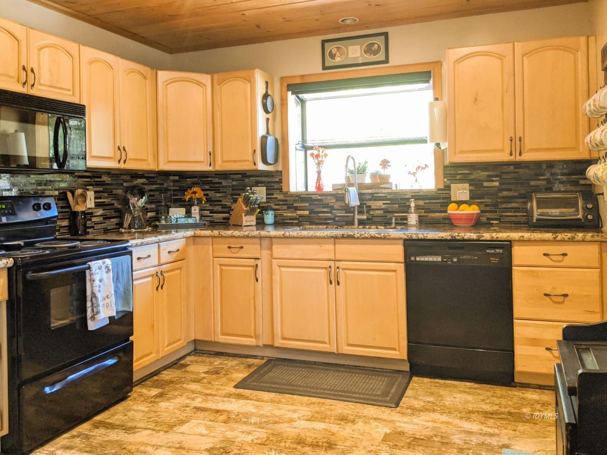 26523 Pine Avenue Idyllwild, CA 92549 - Photo 32 of 56 a kitchen with stainless steel appliances granite countertop a stove a sink and a microwave