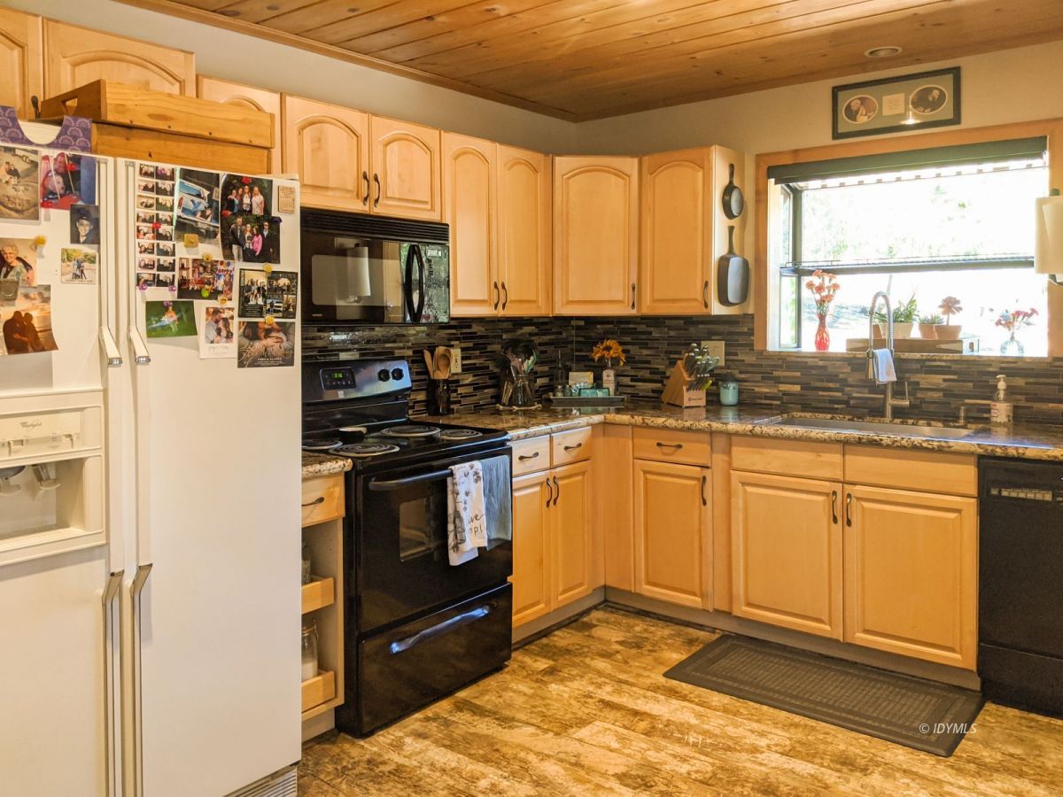 26523 Pine Avenue Idyllwild, CA 92549 - Photo 35 of 56 a kitchen with stainless steel appliances granite countertop a stove a sink and a microwave