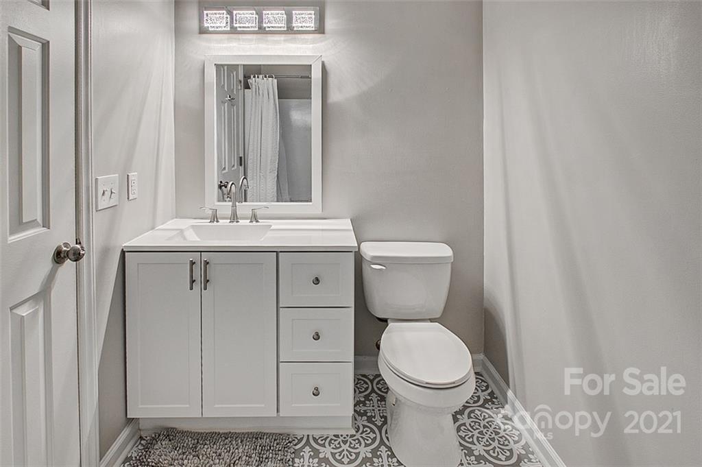 928 Meadowbrook Road Asheboro, NC 27203 - Photo 15 of 25 a bathroom with a toilet a sink and a mirror