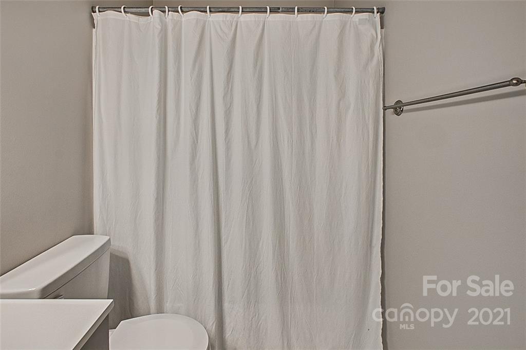 928 Meadowbrook Road Asheboro, NC 27203 - Photo 19 of 25 a white toilet sitting next to a small bathroom