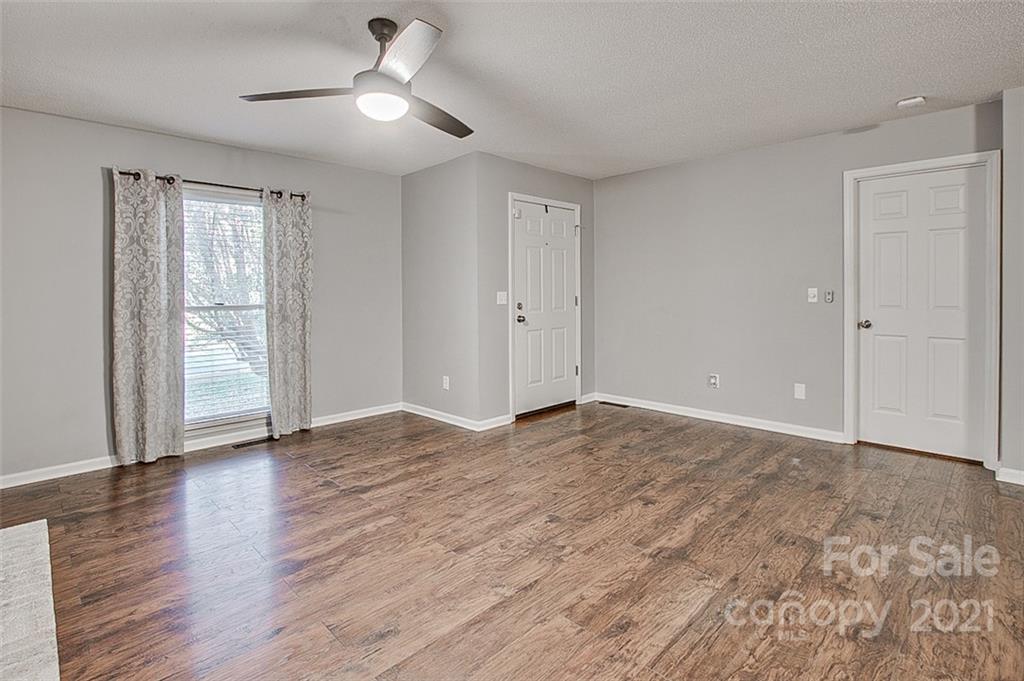 928 Meadowbrook Road Asheboro, NC 27203 - Photo 3 of 25 a view of empty room with wooden floor and fan