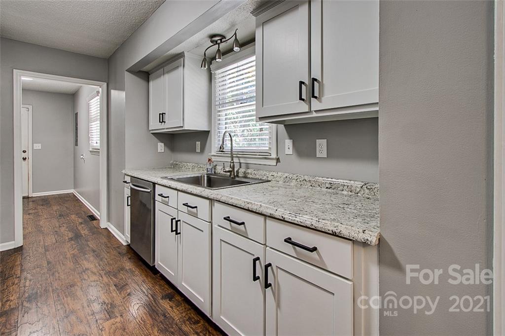 928 Meadowbrook Road Asheboro, NC 27203 - Photo 8 of 25 a kitchen with granite countertop a sink and cabinets