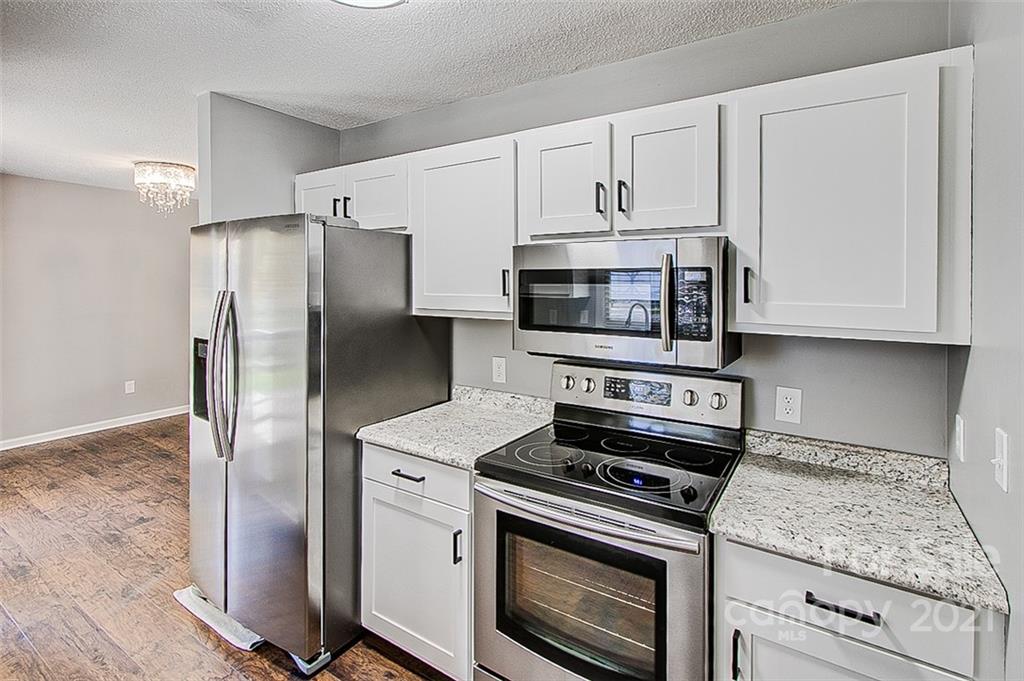 928 Meadowbrook Road Asheboro, NC 27203 - Photo 9 of 25 a kitchen with cabinets stainless steel appliances and a counter space