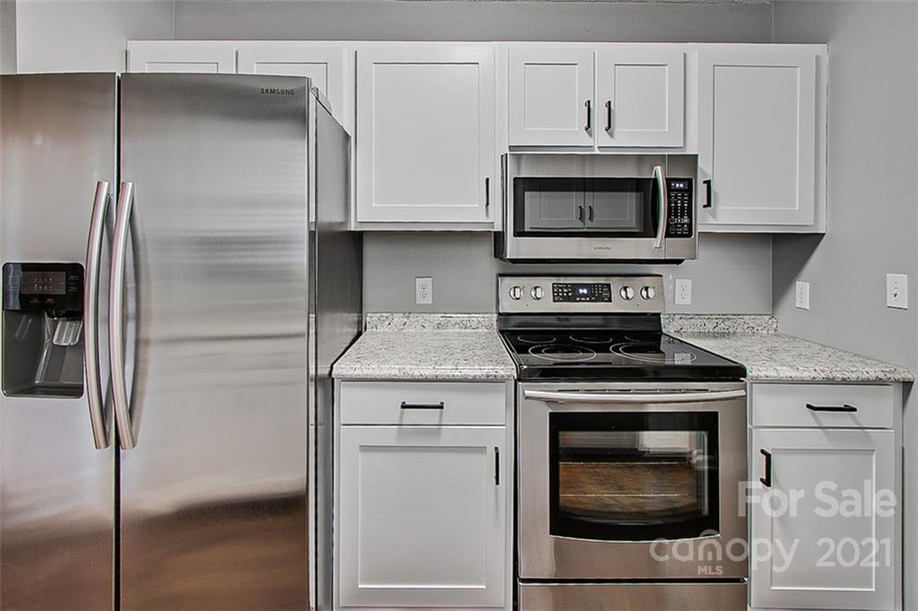 928 Meadowbrook Road Asheboro, NC 27203 - Photo 10 of 25 a stove top oven sitting inside of a kitchen