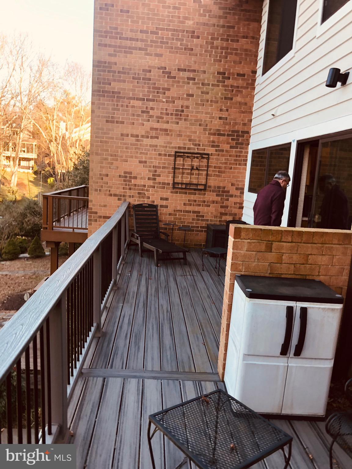 11066 Thrush Ridge Road Reston, VA 20191 - Photo 2 of 3 a balcony with wooden floor and furniture