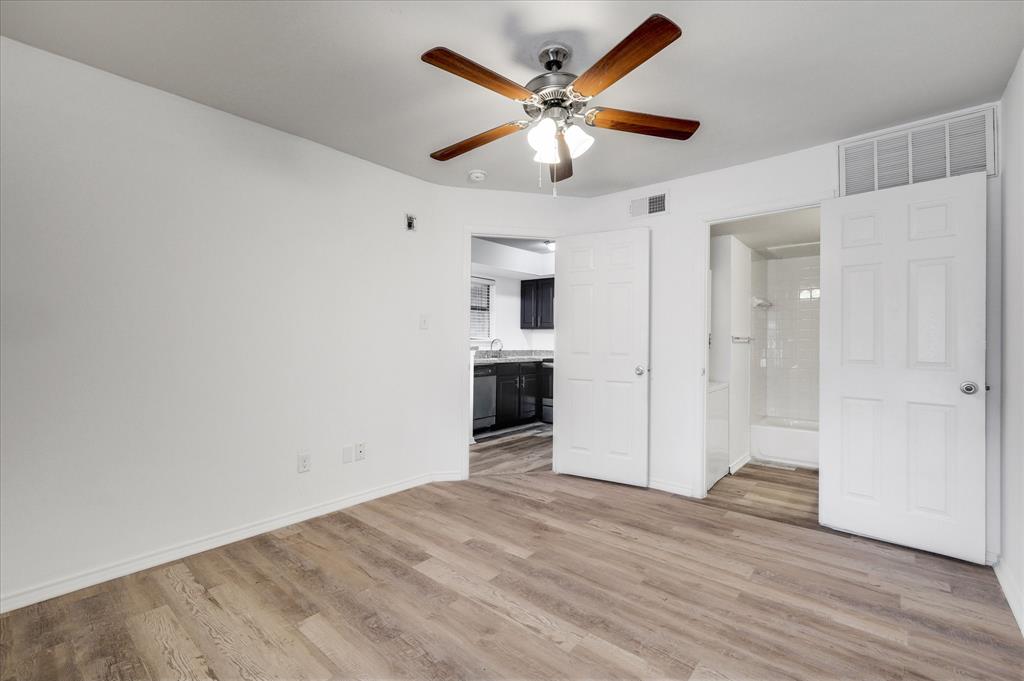 9831 Walnut Street, Unit 212 Dallas, TX 75243 - Photo 14 of 27 Unfurnished bedroom featuring ensuite bathroom, light hardwood / wood-style floors, sink, and ceiling fan
