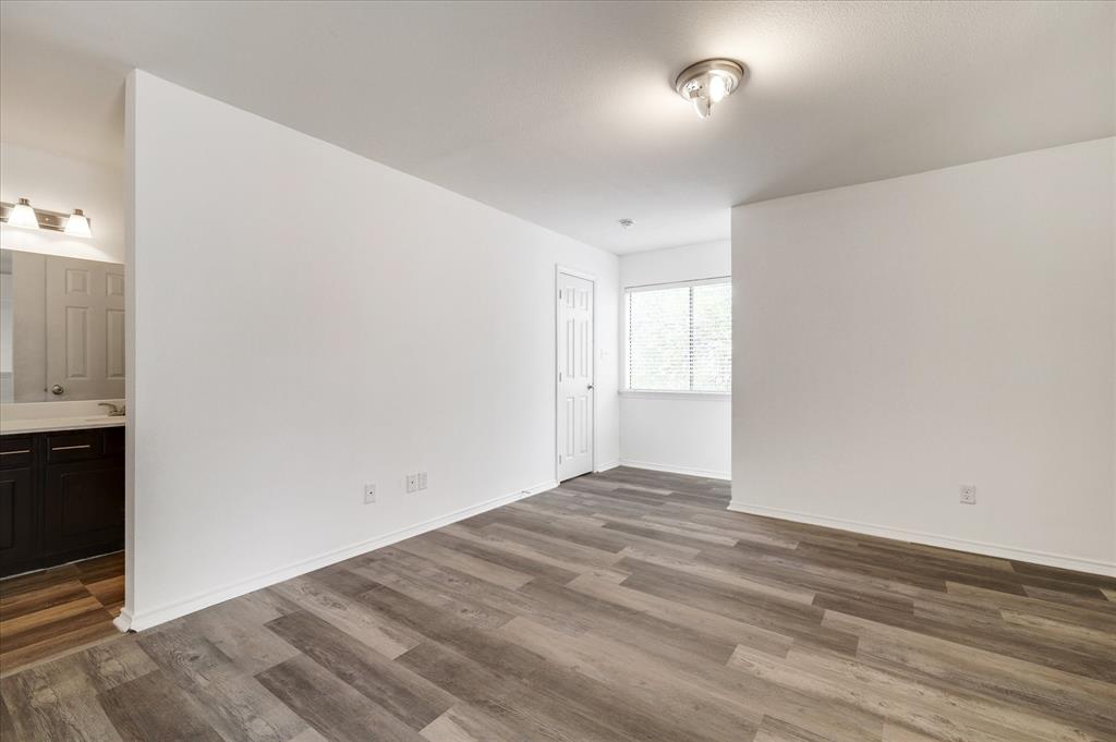 9831 Walnut Street, Unit 212 Dallas, TX 75243 - Photo 17 of 27 Unfurnished room with hardwood / wood-style flooring