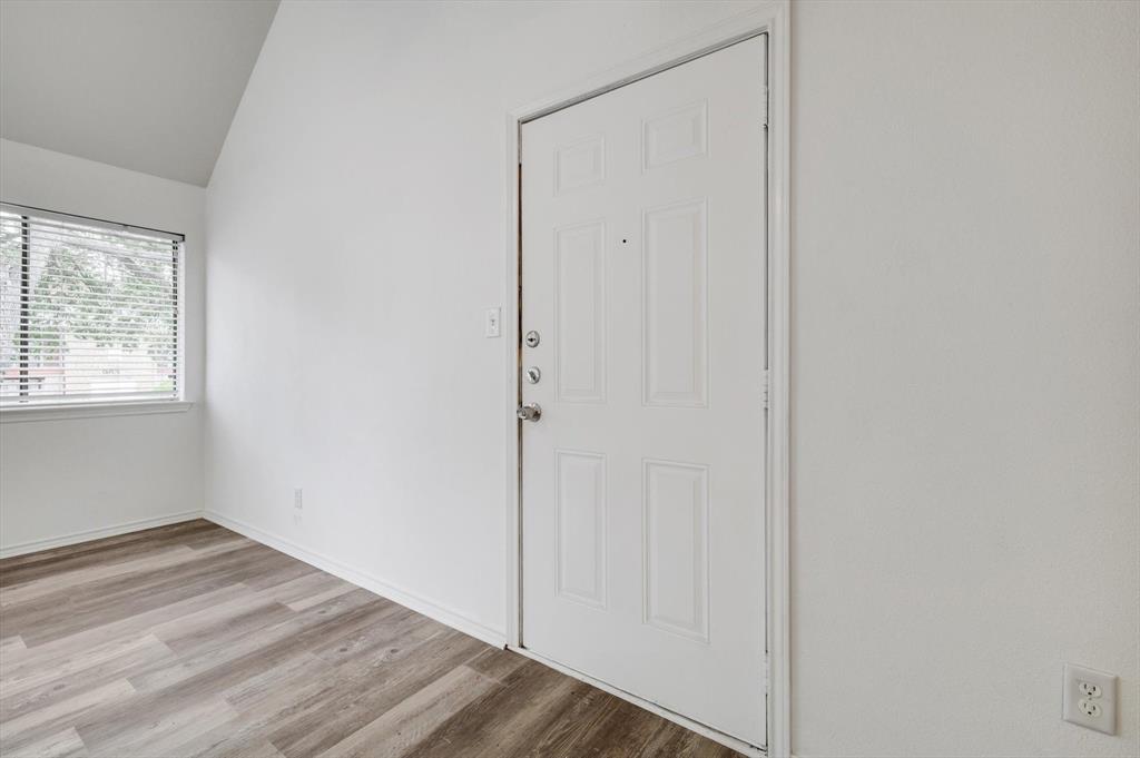 9831 Walnut Street, Unit 212 Dallas, TX 75243 - Photo 4 of 27 Entrance foyer with light hardwood / wood-style flooring and vaulted ceiling