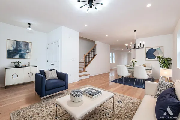 a living room with furniture and a chandelier