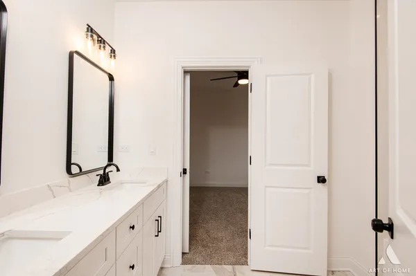 a bathroom with two mirror
