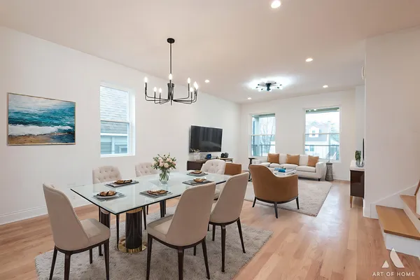 a view of a dining room with furniture wooden floor and a chandelier