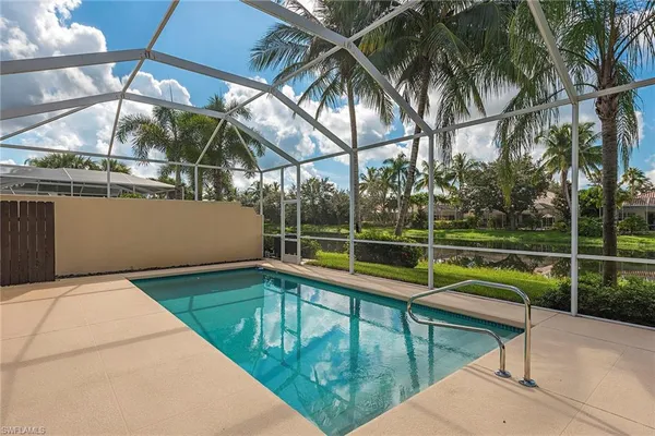 a view of a swimming pool with a patio and a yard