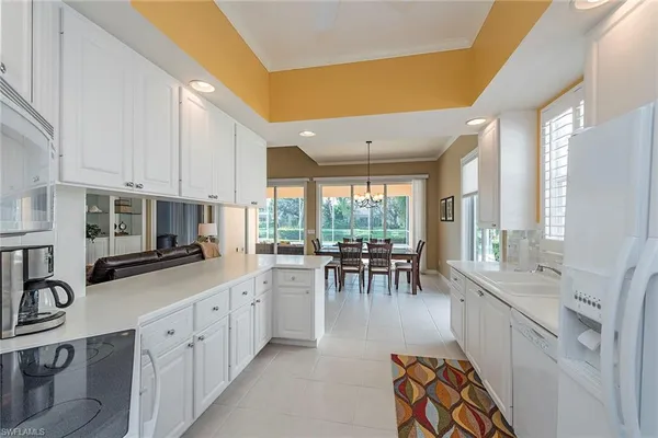 a large white kitchen with lots of counter top space