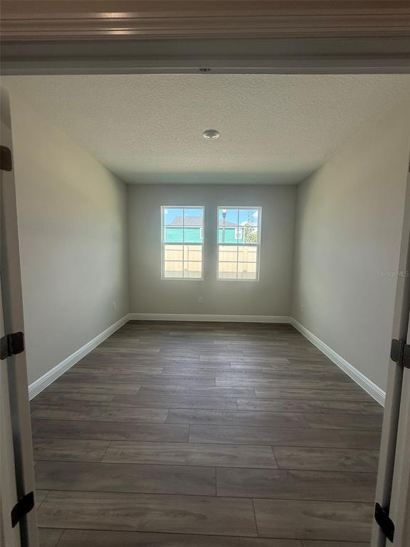 12132 Cattleside Drive Riverview, FL 33579 - Photo 12 of 31 a view of an empty room with wooden floor and a window