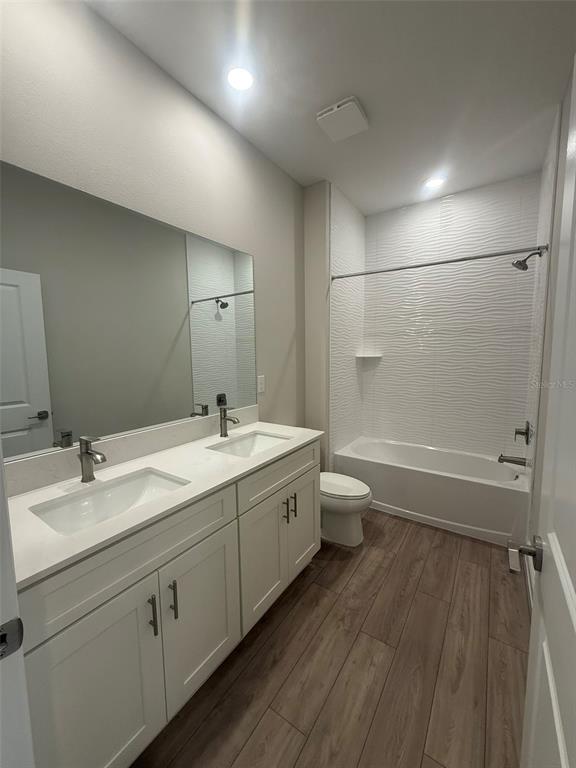 12132 Cattleside Drive Riverview, FL 33579 - Photo 13 of 31 a spacious bathroom with a double vanity sink toilet and a mirror
