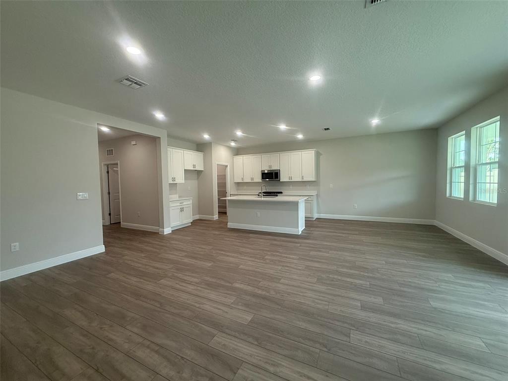 12132 Cattleside Drive Riverview, FL 33579 - Photo 5 of 31 a view of kitchen with kitchen island wooden floor wooden floor and refrigerator