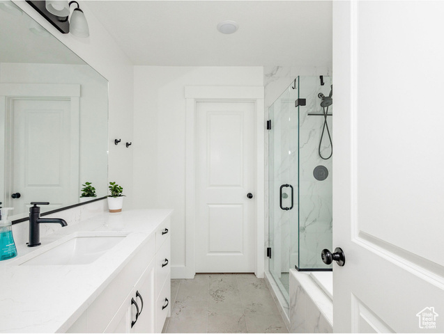 374 Ropelato Drive Nibley, UT 84321 - Photo 13 of 15 Full bathroom with vanity, a marble finish shower, and marble look tiles